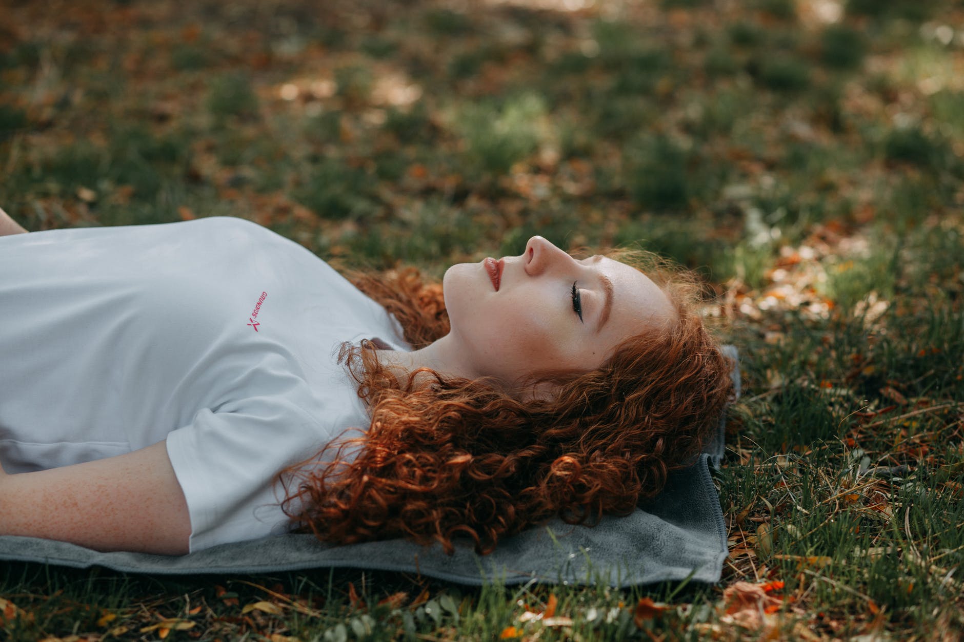 photo of woman laying on ground